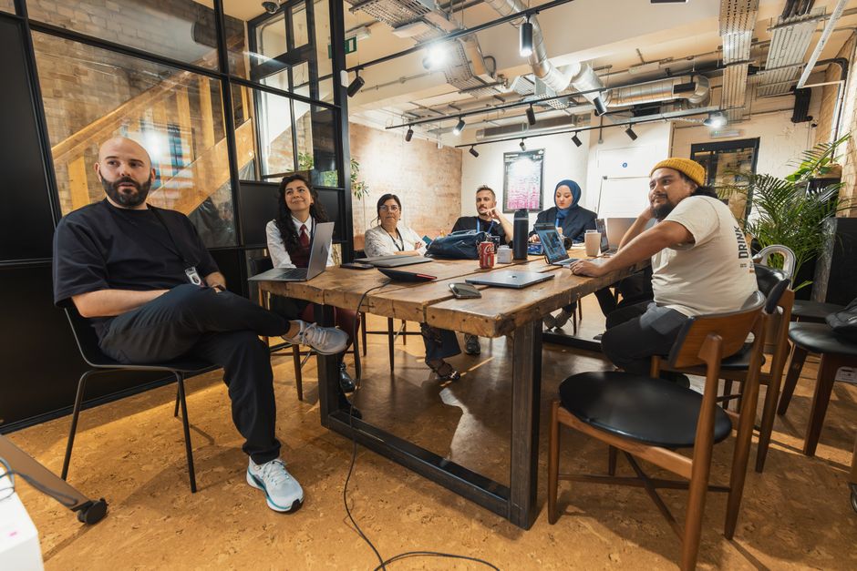 A team of therapists and a parent meeting around a table