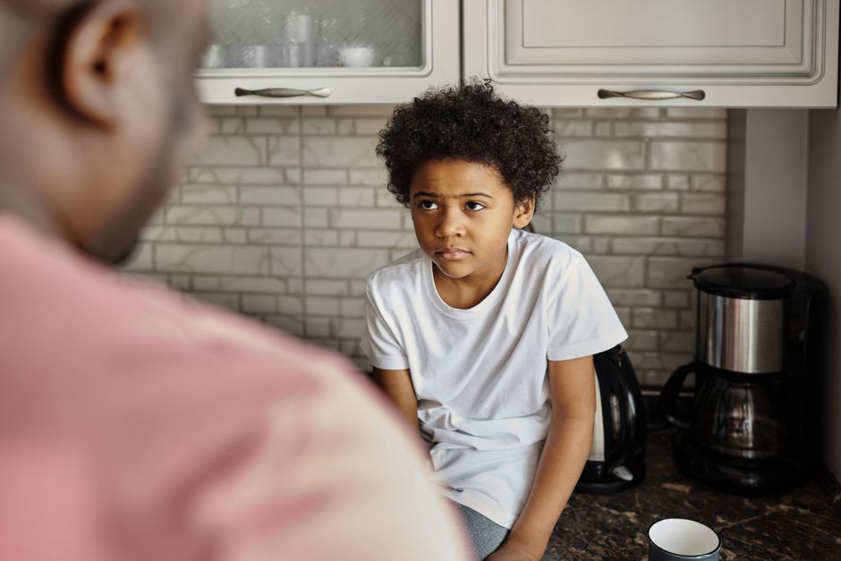 Parent calmly talking with their child at home