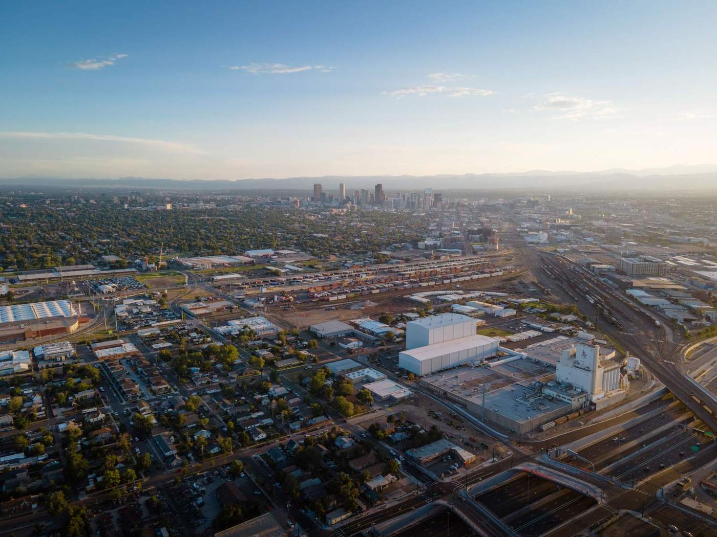 Aerial view of Denver, Colorado, with the Rocky Mountains in the distance. Budding Futures ABA serves families across the city from its Denver office.