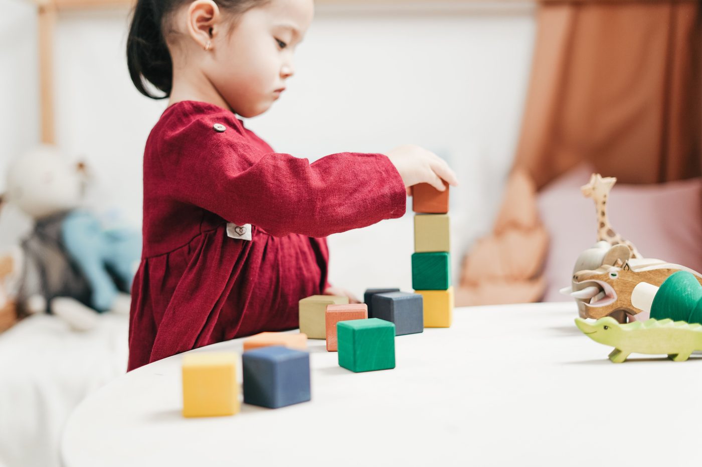 A young girl engaging with colorful wooden blocks