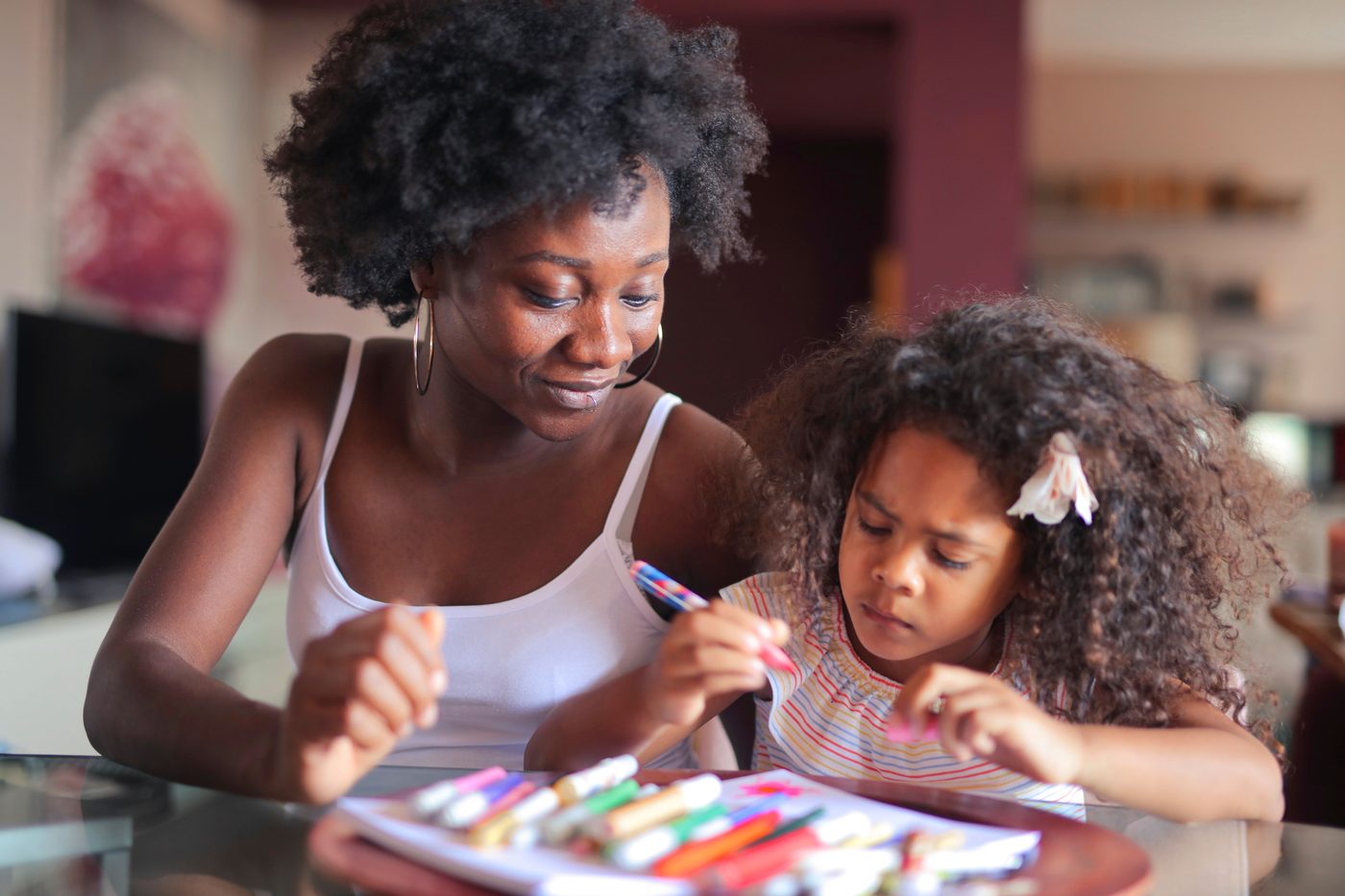 A loving moment as a mother and daughter engage in drawing together at home