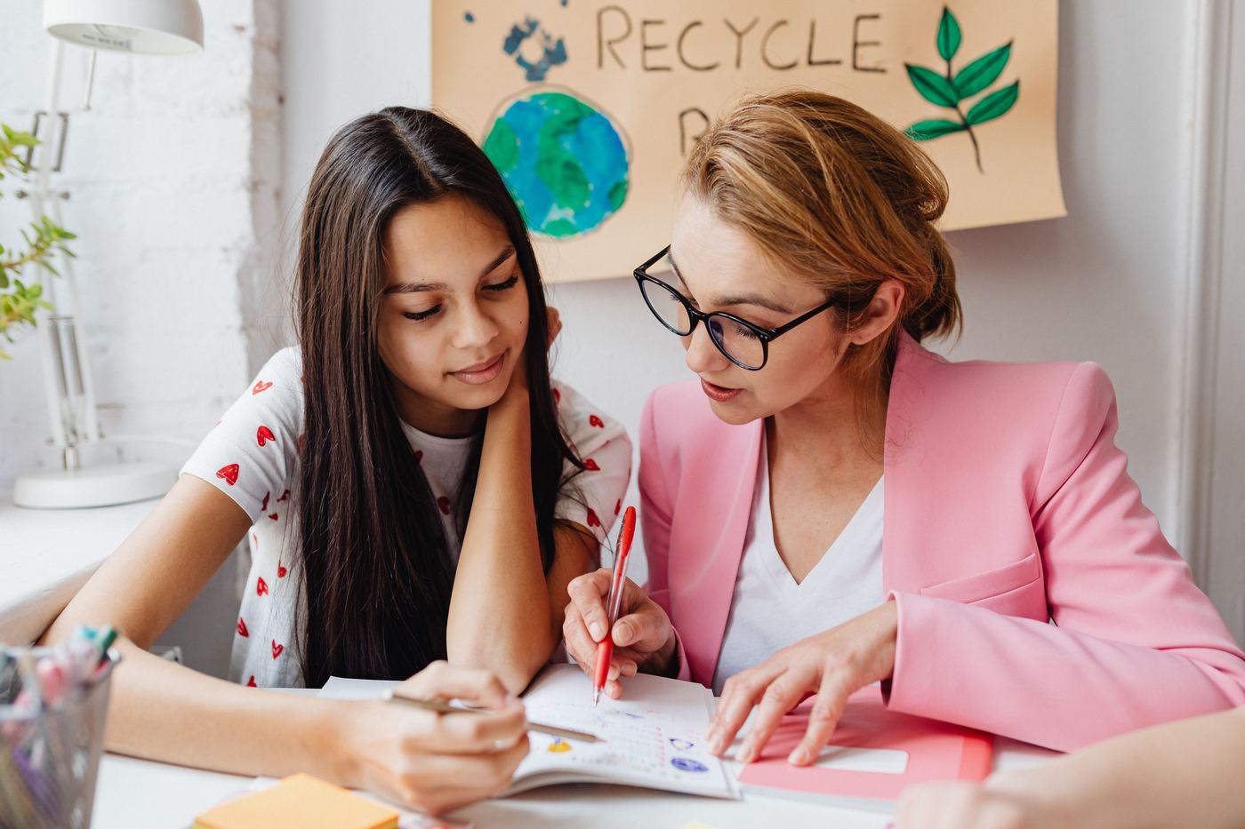 Teacher assists student with homework
