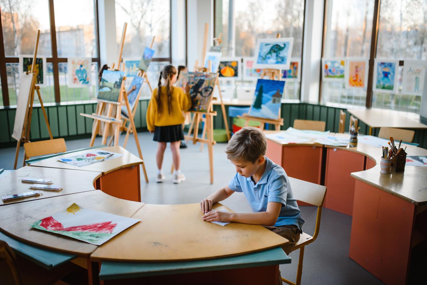 Children in a lively classroom setting inspire creativity through art activities and exploration