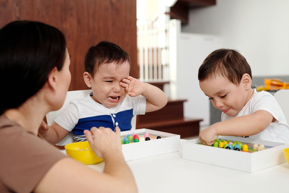 Parent calmly comforting an upset young child