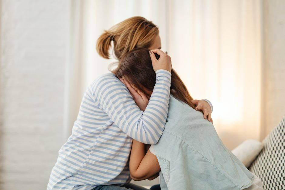 Parent comforting and soothing a young child