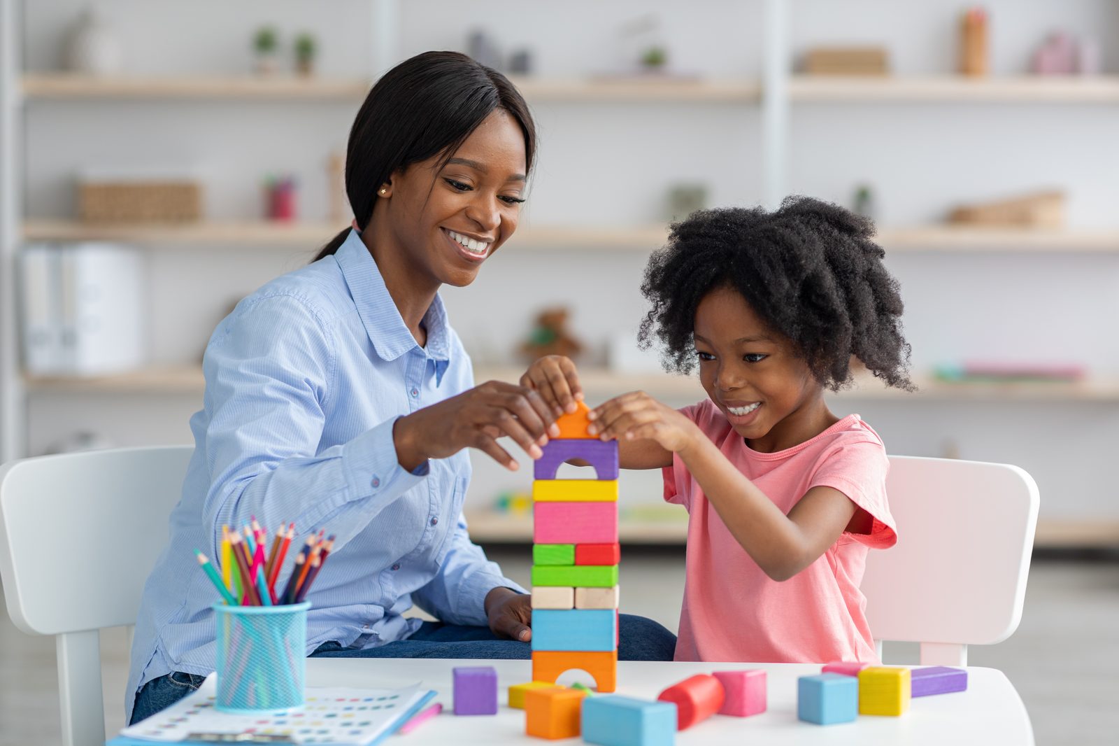 Therapist and child communicating through play-based activity